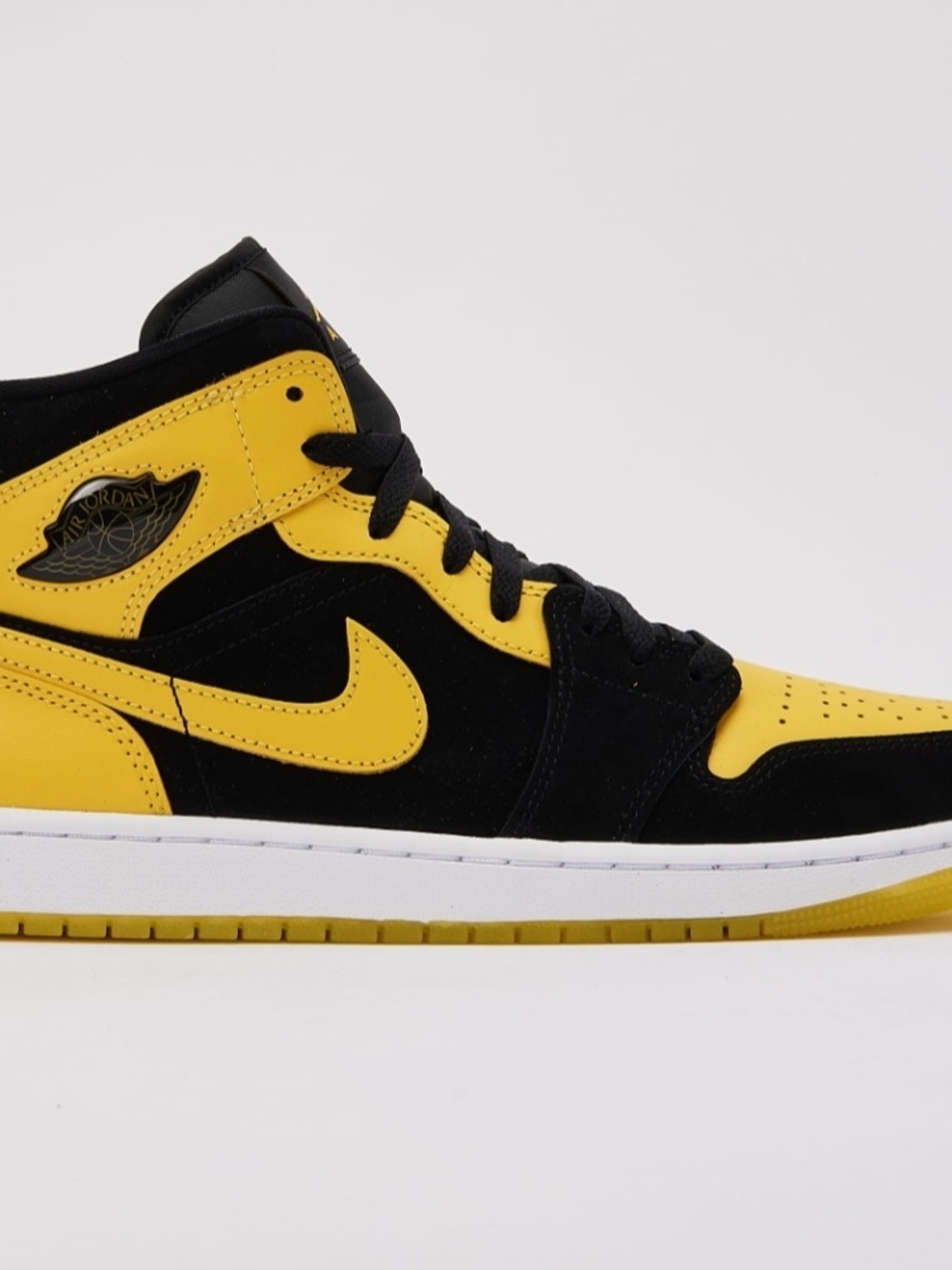 Nike Air Jordan 1 Mid Black and Yellow Swoosh Sneakers